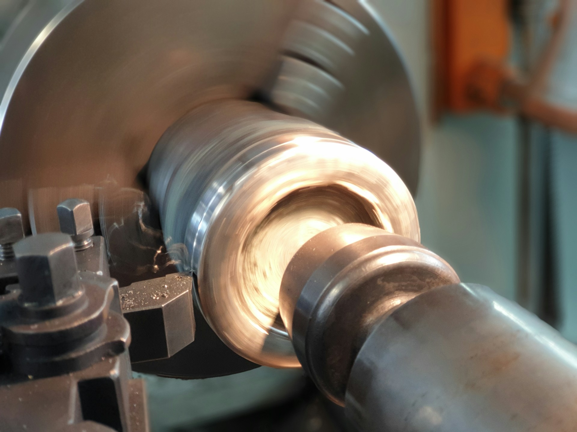 Metal lathe turning a steel workpiece in a machine shop