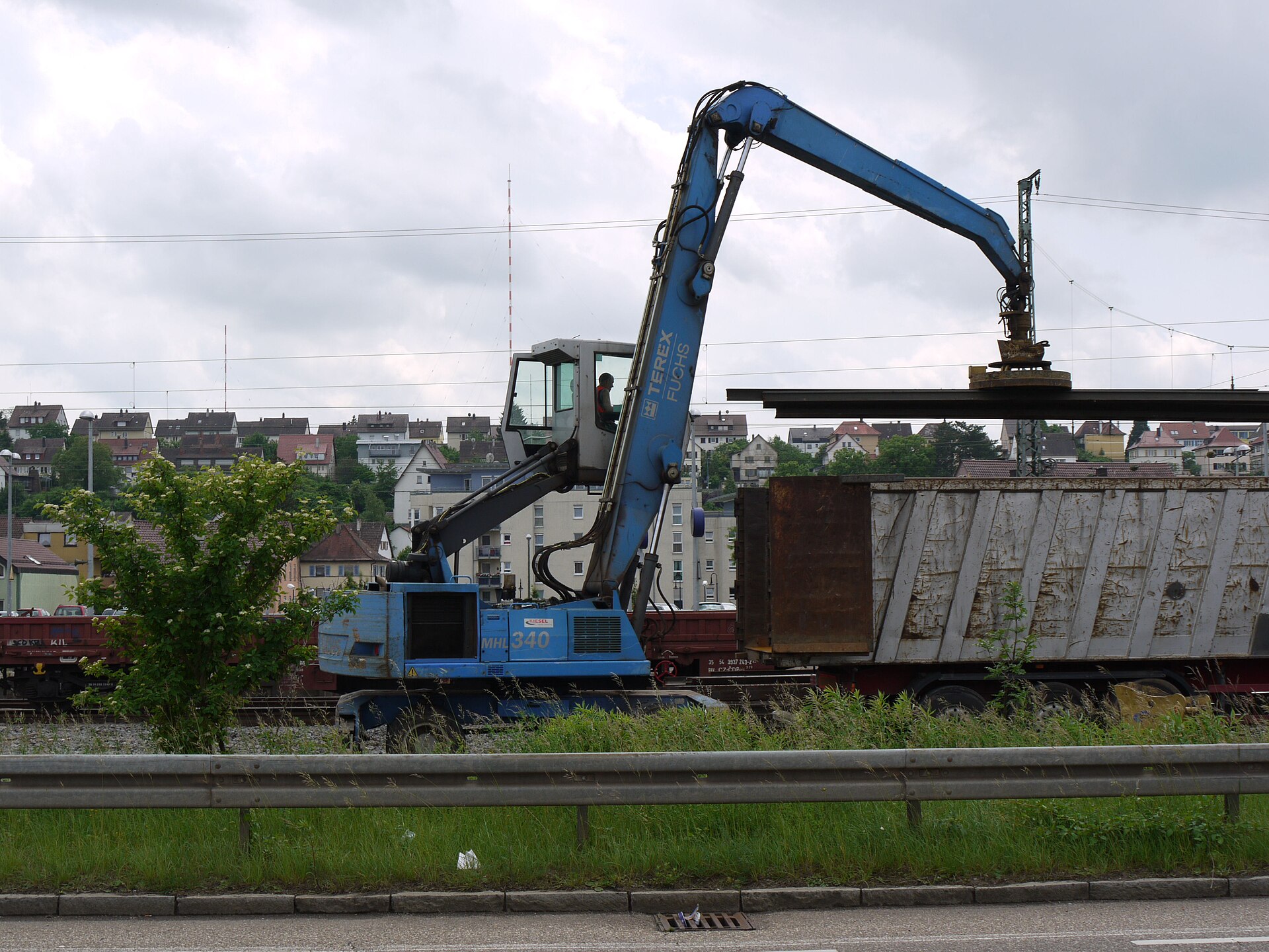 Mobile crane with an industrial lifting electromagnet handling steel rail